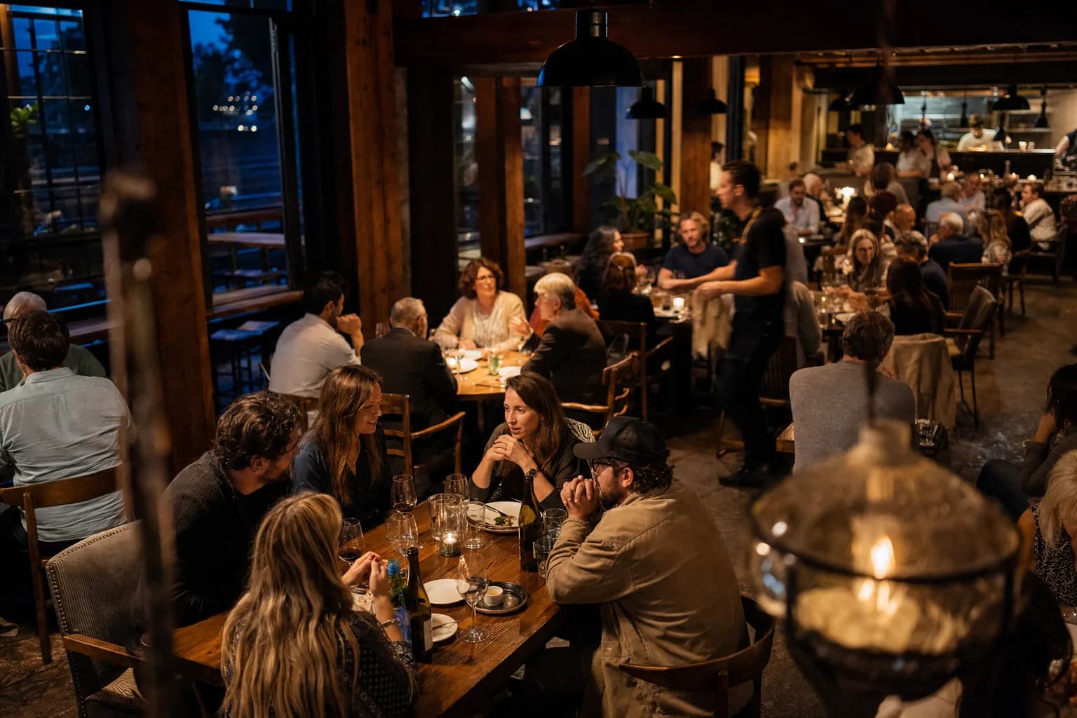 A full restaurant dining room during evening service